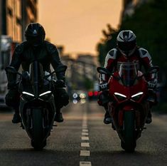 two motorcyclists are riding down the street in front of each other on their bikes