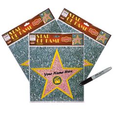 three star stickers with the name of fame written on them and one has a pen in front of it