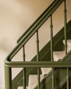 the stairs are painted green and have white cushions