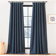 a blue curtain hanging in front of a window