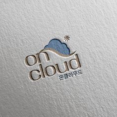 the logo for on cloud is shown in grey and blue colors, with an image of clouds