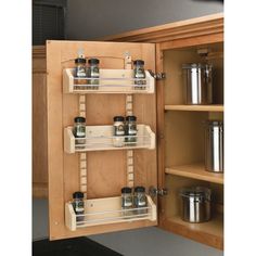 a kitchen cabinet with spice racks in it