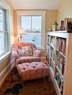 a living room filled with furniture next to a book shelf full of lots of books