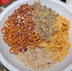 a white plate topped with lots of different types of cereal and crackers on top of it