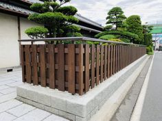 a wooden fence on the side of a road