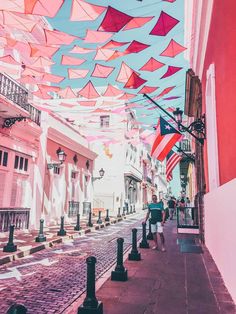 people walking down the street under colorful umbrellas