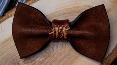 "Leather Bow Tie - an accessory that gives an opportunity to play with style, change its appearance, be fashionable, extravagant, presentable. Minimalist design, unisex. Bow tie made of 100% mat genuine cowhide leather (calf leather) made in Italy. Size: - 6x11 cm. (2.3x4.3\") - strap is regulated; - the width of strap is 1.5 cm. (3/4\"). It is very comfortable to use. Color on photo: Brown It is a unique accessory to have a perfect outfit on the entertainment, or on the stag party or in everyda Brown Bow Tie, Wedding Bow Tie, Leather Bow Tie, Ring Boy, Groomsmen Bowtie, 3rd Anniversary Gifts, Gifts For Fiance, Bow Tie Wedding, Leather Bow