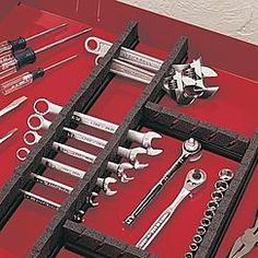 tools are laid out on a red tray with scissors and wrenches in the middle