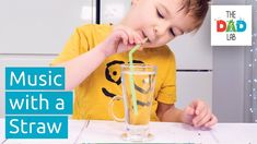 a young boy drinking from a glass with a straw in it and the words music with a straw