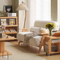 a living room filled with furniture next to a white couch and coffee table in front of a window