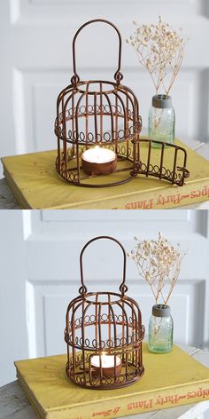 two bird cages with candles in them sitting on a table