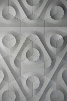 an abstract pattern made up of hexagonal shapes in white and grey tones with black accents