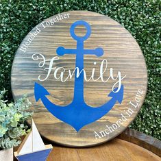 a wooden sign with an anchor on it that says family and another is in the background