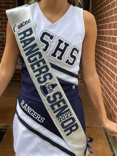 a woman in a white and blue cheer uniform is holding a ribbon that says race recap