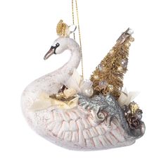 a white swan ornament hanging from a gold and silver christmas tree ornamentset