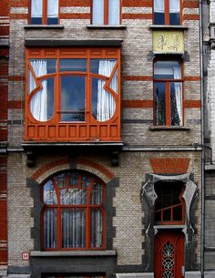 an orange and grey building with two red doors