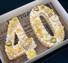 a cake shaped to look like the number forty with flowers and hearts on it in a box