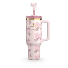 thermos cup with handle is decorated with pink flowers and gold trimmings