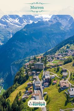 an aerial view of a town surrounded by mountains