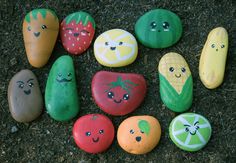 rocks painted to look like fruits and vegetables are arranged in a circle on the ground