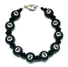 This listing is for a brand new handmade Black 8 Ball Bracelet....It is made with 11mm acrylic 8 ball beads, 8mm black bicone beads and an antique silver-plated trigger clasp that measures 15x8mm....The bracelet measures 7-3/4"....Comes in an organza bag....I do combine shipping....Please check out my store for more bracelets and hundreds of great items....Thanks for looking. 8 Ball Jewelry, Rave Bracelets, Ball Jewelry, Clothing Board, Ball Bracelet, 8 Ball, Bracelets And Charms, Organza Bags, Cute Jewelry