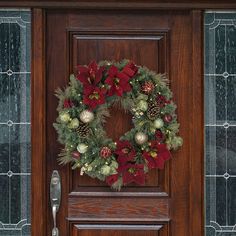 a wooden door with a christmas wreath on it