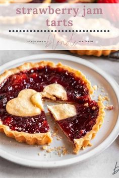 strawberry jam tarts on a white plate with one slice missing