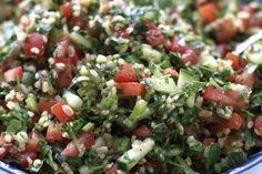 a salad with tomatoes, cucumbers and other veggies in a bowl