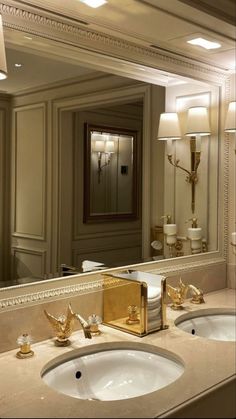 a bathroom with two sinks and a large mirror