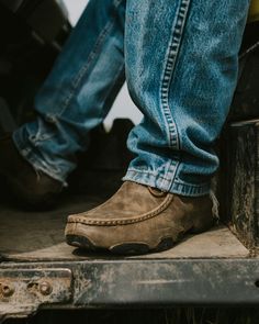 The men’s casual chukka driving moc is a true Twisted X® original! Handcrafted in genuine full-grain leather, the chukka driving moc makes an unforgettable statement about true comfort and style in casual footwear. Blending together a traditional open-laced profile with a unique leather-wrapped outsole and moc toe design with integrated comfort technology that provides timeless quality and style. The SD footbed, composite XD insole, and the Twisted X® driving moc outsole combine to produce one o Twisted X Outfits, Driving Mocs, Casual Footwear, The Men, Toe Designs, Leather Wraps, Full Grain Leather, Desi, Casual Shoes