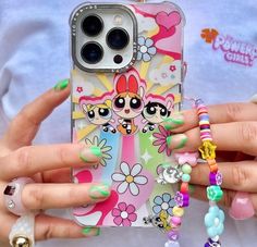 a person holding a cell phone case with flowers and cats on it's side