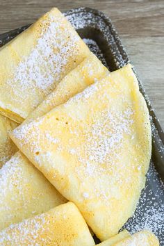 some pastries are sitting on a plate with powdered sugar sprinkles