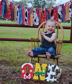 a baby sitting in a rocking chair next to a sign