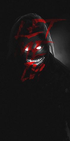 a man wearing a scary mask in the dark with red light coming from his eyes