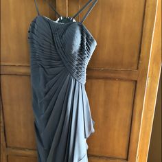 a blue dress hanging on a wooden door