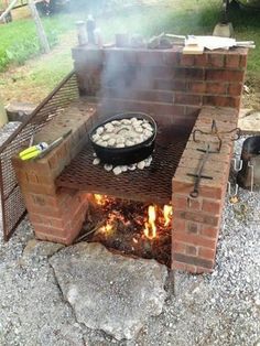 an outdoor grill with food cooking on it's sides and fire in the middle