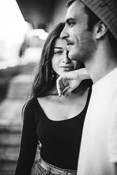 a man and woman standing next to each other with their hands on their chins