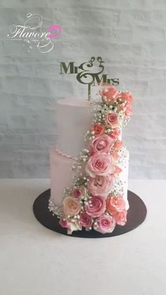 a wedding cake with pink flowers on top