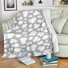 a living room with a couch covered in a gray and white polka dot print blanket