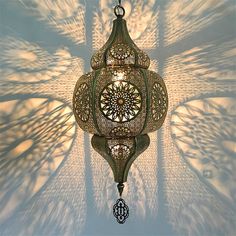 an intricately designed lamp hanging from a ceiling