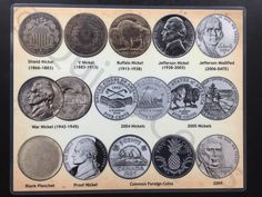 an old coin collection is displayed on a plaque with the names and dates in it