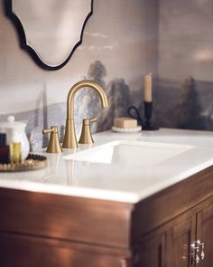 a bathroom sink with two faucets and soap dispensers on the counter