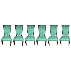 six green velvet dining chairs with wooden legs