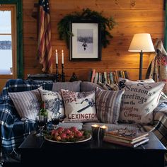 a living room filled with lots of furniture next to a wall covered in wooden planks