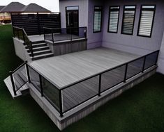 a 3d rendering of a house with decking and railings