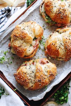 ham and cheese croissants with parmesan cheese on the side are ready to be eaten