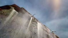 the sun shines brightly through the clouds in the sky above a water slide at an amusement park