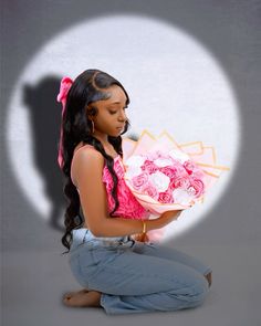 a woman sitting on the floor holding a bouquet of roses