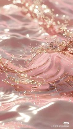 the water is pink and shiny with some gold flecks on it's surface