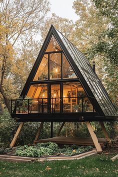 a - frame cabin in the woods surrounded by trees